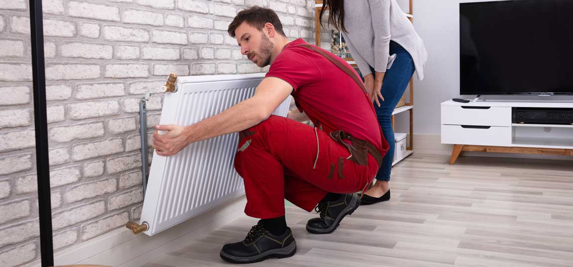 Man removing radiator 