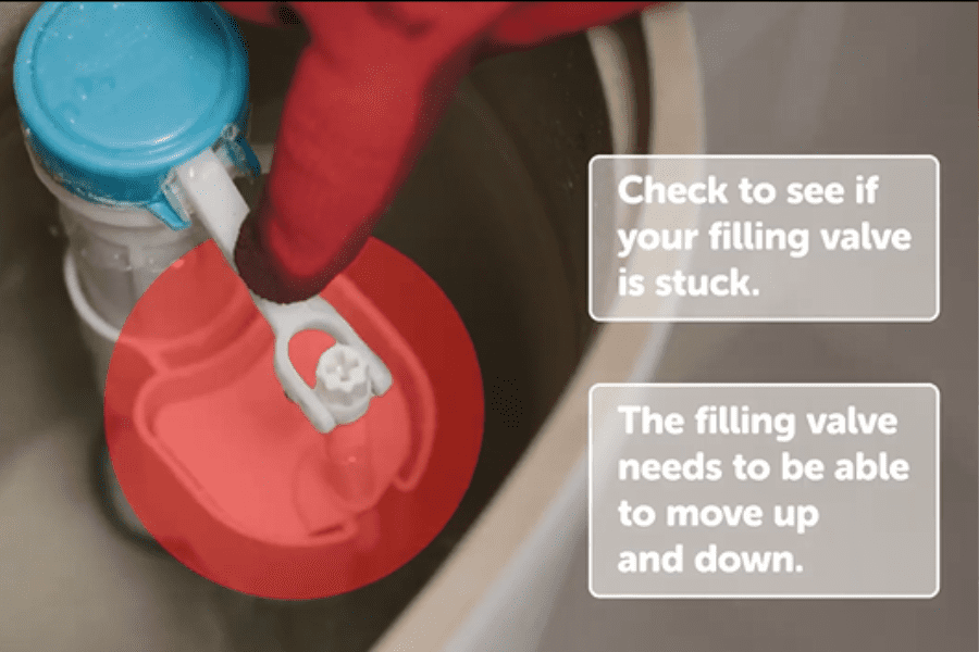 Image showing a HomeServe engineer testing the toilet filling valve for obstructions to fix a toilet that keeps running 